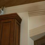 Detail of custom cabinets with trim matching cornice design.